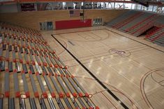 an indoor basketball court with rows of seats