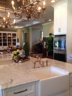 a kitchen with a sink, stove and oven in it's center island area