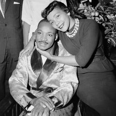 an old black and white photo of a woman getting her hair combed by a man