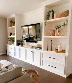 a living room filled with furniture and a flat screen tv on top of a wall