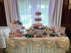 a table topped with lots of cakes and cupcakes