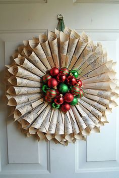 an ornament made out of folded book pages is hanging on the front door