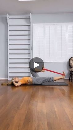 a woman is doing an exercise on the floor