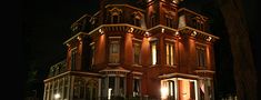 an old building with a clock tower lit up at night