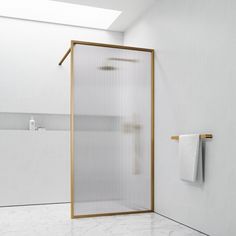 a white bathroom with a glass shower door