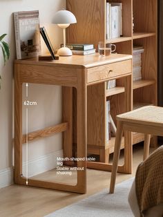 a wooden desk sitting next to a book shelf with books on top of it and a lamp