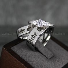 two wedding rings with the words bride and groom engraved on each ring, sitting on top of a wooden box