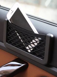 a cell phone in a holder on the dashboard of a car