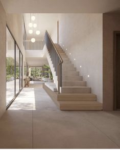 an empty hallway with stairs leading up to the second floor