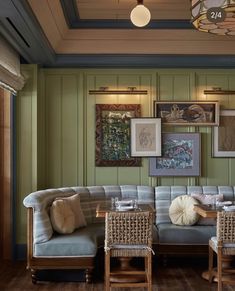 a living room filled with furniture and pictures on the wall