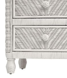 a white wicker nightstand with two drawers and one drawer on the bottom, against a white background