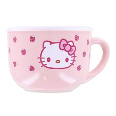 a pink hello kitty coffee cup with strawberries on it