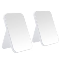 two white mirrors sitting next to each other