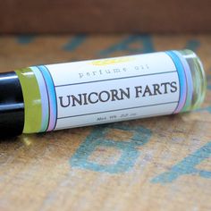 an unicorn farts roll - on is sitting on the floor in front of a couch