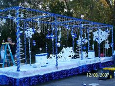 a blue and white decorated stage with snowflakes on it