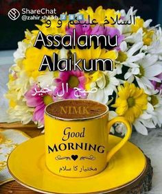 a yellow coffee cup sitting on top of a saucer next to some white and yellow flowers