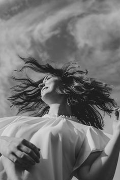 a woman with her hair blowing in the wind