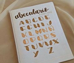 a notebook that has some type of writing on it with the letters and numbers written in cursive ink