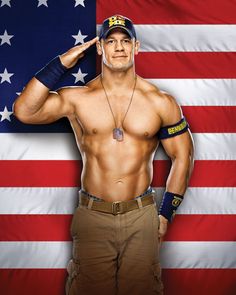 a shirtless man standing in front of an american flag with his hands on his head