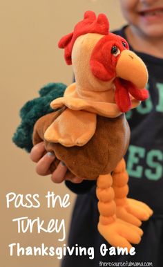 a young boy holding a stuffed chicken in his hands