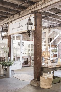 the inside of a store with lots of furniture and lamps on display in front of it