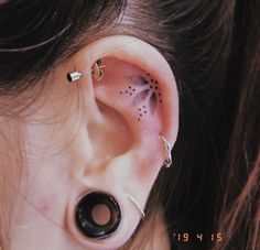 a woman's ear has a black and white design on it