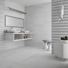 a white bathroom with two sinks and a mirror