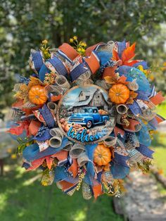 a wreath with an orange and blue car on it