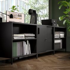 a black cabinet with many files and folders in it next to a potted plant