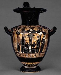 an old vase with people on it sitting in front of a gray background and grey backdrop