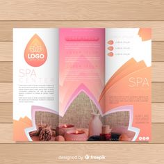 an elegant spa brochure is displayed on a wooden table with candles and flowers