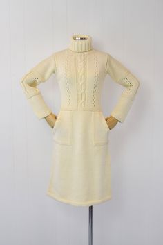 "Info: ♥ Circa: 70s ♥ Label: Courreges (tag is missing but the embroidery on the bodice is unmistakable) ♥ Color: Cream ♥ Material: Wool ♥ Condition: Excellent vintage condition. Details: ♥ Cozy Courreges sweater dress ♥ Soft cream colored wool ♥ High turtleneck ♥ Two pockets, one on each side ♥ Pullover style, no closures ♥ Unlined Measurements: Bust: 32\"-snug 40\" Waist: 28\"-32\" Hips: 38\"-42\" Length: 42.5\" Sleeve Length: 19\" ♥ ♥ All garments are measured flat, then doubled for the bust, Retro Fitted Vintage Dress For Winter, Fitted Retro Vintage Dress For Winter, Fitted Knee-length Vintage Dress For Winter, Vintage Cream Dress For Fall, Vintage Beige Dress For Winter, Retro Winter Daywear Dresses, Retro Winter Day Dresses, Vintage Beige Dresses For Winter, Long Sleeve Cream Dress For Vintage Fashion