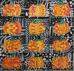 an art project with pumpkins painted on black and white paper, surrounded by circles