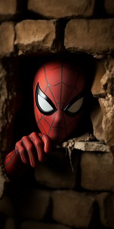 a spider - man peeks out from behind a brick wall