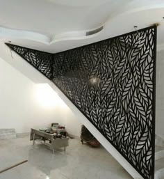 an artisticly designed stair case in the middle of a room with white walls and flooring