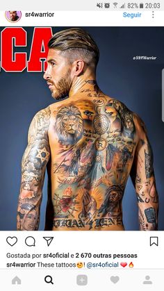 a man with lots of tattoos on his back and chest is looking at the camera