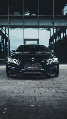 a black car parked in front of a building