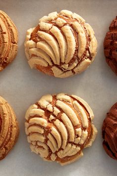 four cookies with icing on them sitting next to each other