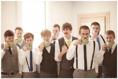 a group of men standing next to each other holding coffee mugs in their hands