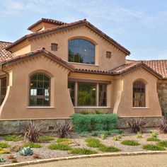 a large house with many windows and landscaping