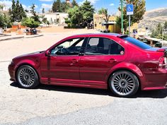 a red car is parked on the street