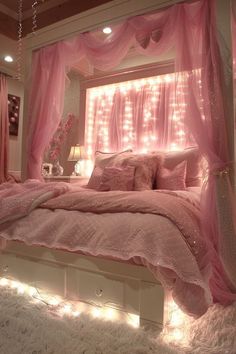 a bed with pink bedspread and lights on the headboard in a bedroom