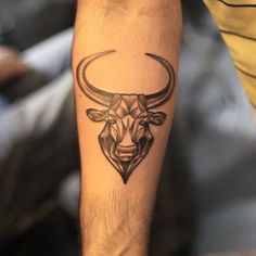 a man with a bull tattoo on his arm