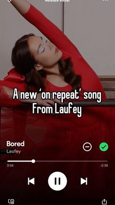 a woman laying on top of a bed with headphones in her hand and the caption reads, a new'on repeat song from lauley