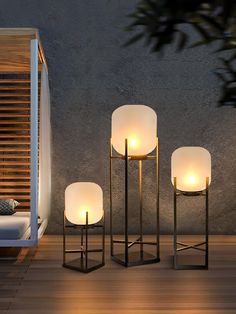 three lamps sitting next to each other on a wooden floor