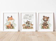 three framed pictures with animals on them in front of a white wall and wooden floor