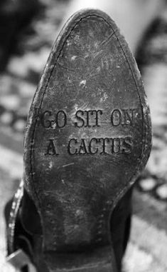 an old pair of shoes with the words go sit on a cactus written on them