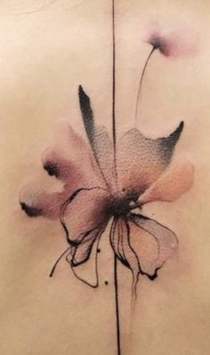 the back of a woman's stomach with flowers painted on her chest and in black ink