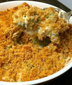 a close up of food in a bowl with a spoon