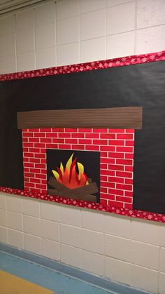 a fire place is painted on the wall next to a blackboard with red and yellow flames